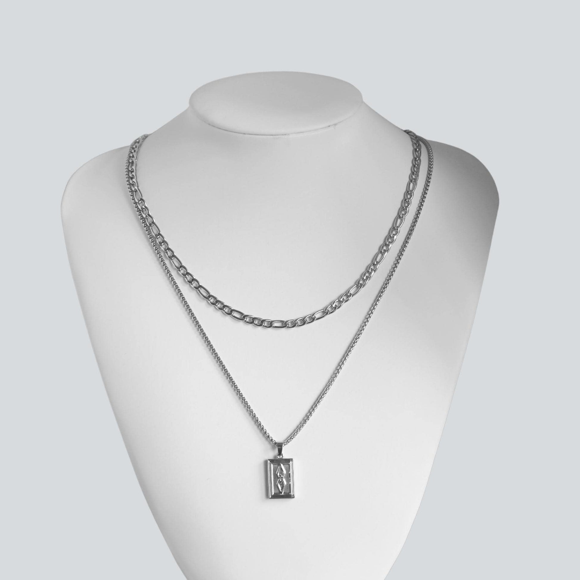 https://wearrenn.com/cdn/shop/products/silver-rectangle-pendant-and-45mm-figaro-chain-necklace-set-for-men-boutique-wear-renn-920330.jpg?v=1682435725&width=1946